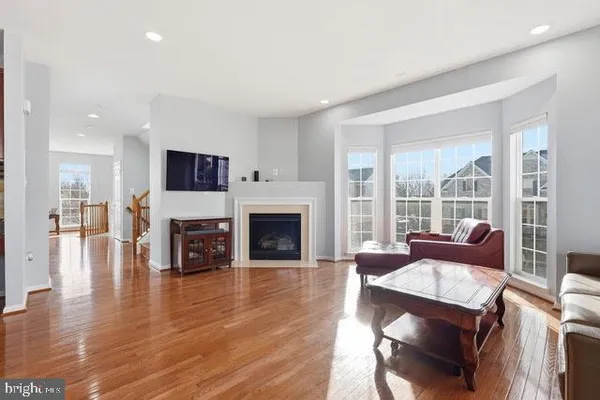 a living room with furniture fireplace and flat screen tv