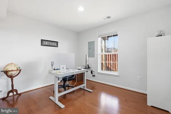 a view of a workspace with furniture and a window