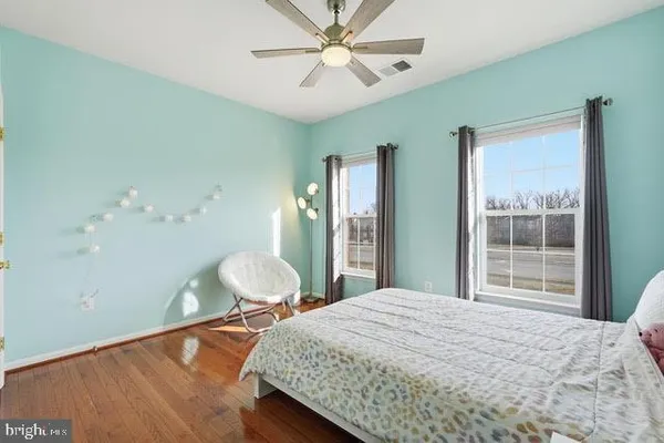 a bedroom with a bed dresser and a window