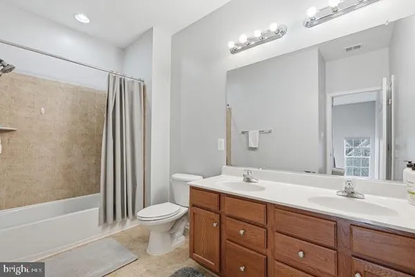 a bathroom with a double vanity sink and a mirror