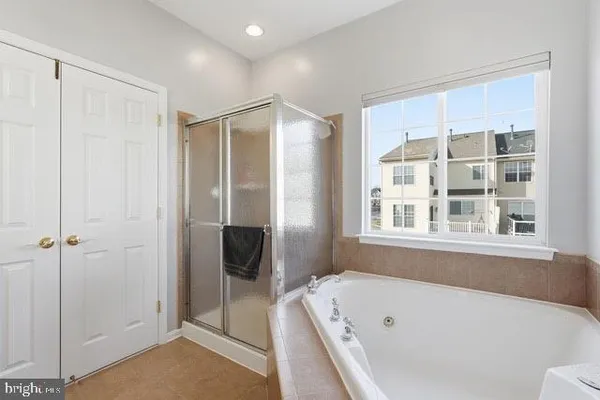 a bathroom with a bathtub and a shower