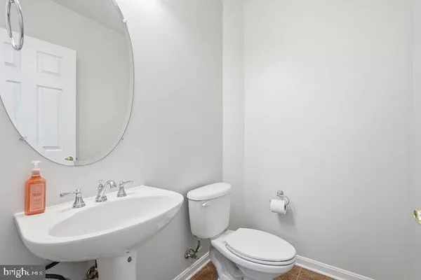 a bathroom with a sink a toilet and mirror