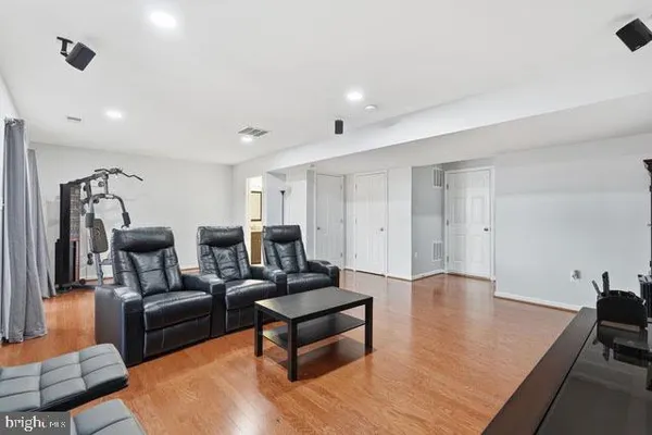 a living room with furniture and a wooden floor