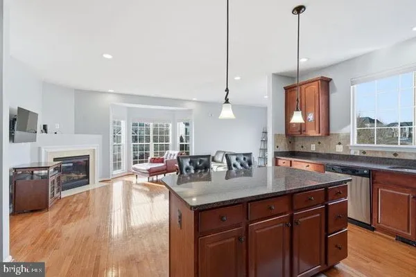 a kitchen with a sink a center island and furniture