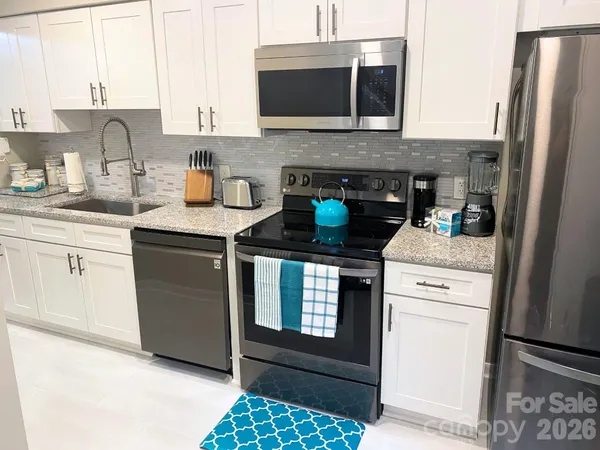 a kitchen with a stove and refrigerator