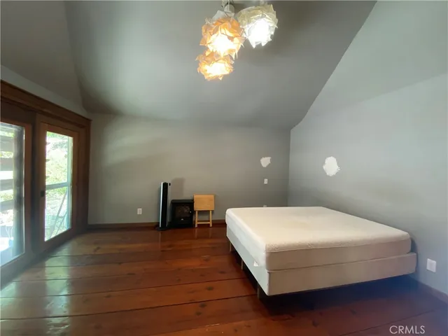 a bedroom with a large bed and a chandelier