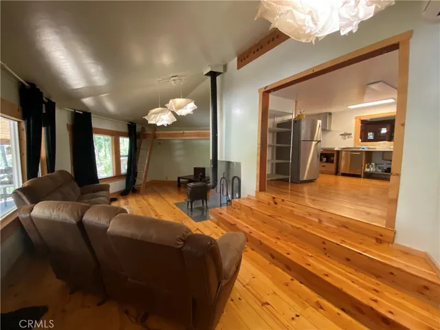 a living room with fireplace furniture and a flat screen tv