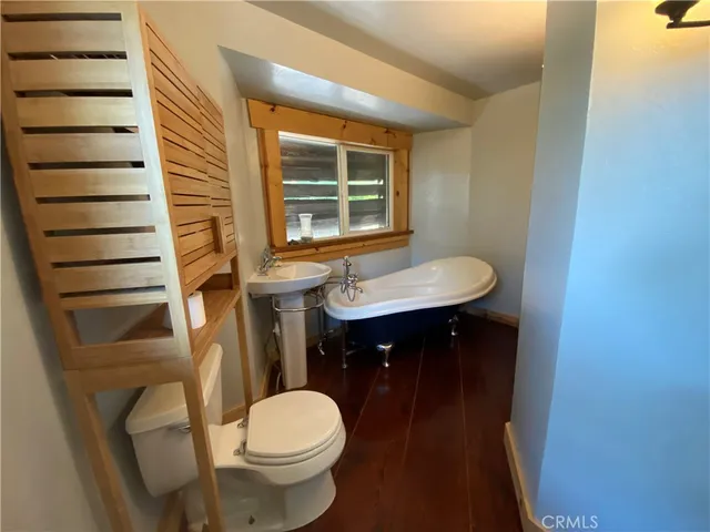 a large kitchen with stainless steel appliances a refrigerator and a stove top oven