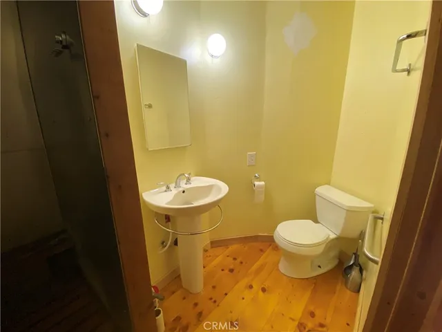 a bathroom with a shower a sink and mirror