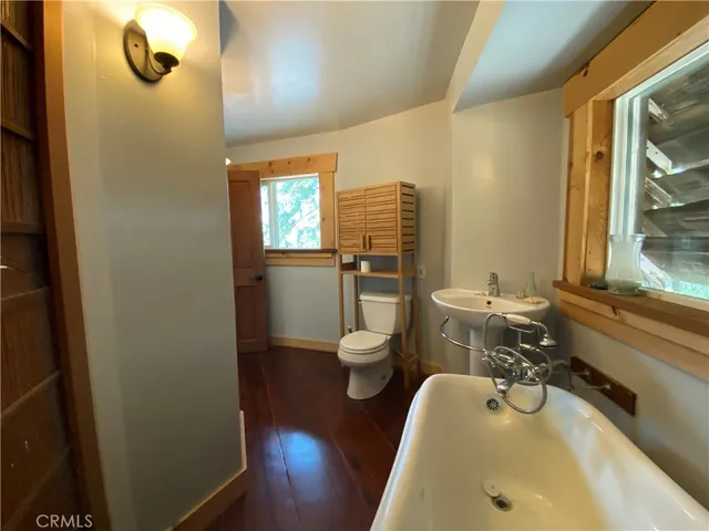 a view of a livingroom with hardwood floor and a ceiling fan