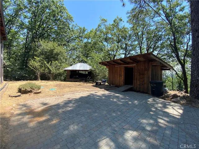 a wooden bench sitting in the middle of a yard