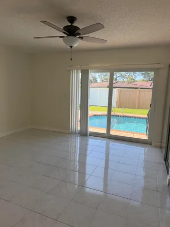 an empty room and chandelier fan