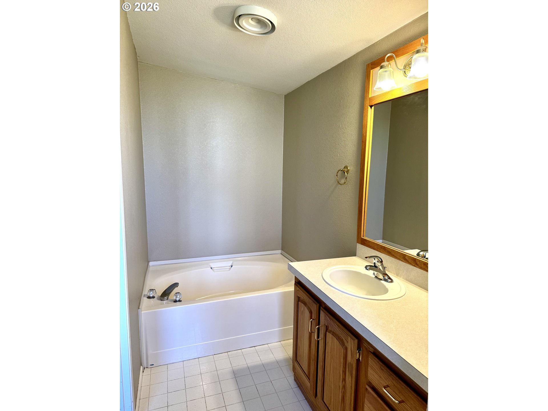 1070 Grove Street Baker City, OR 97814 - Photo 11 of 30 a bathroom with a tub sink and mirror