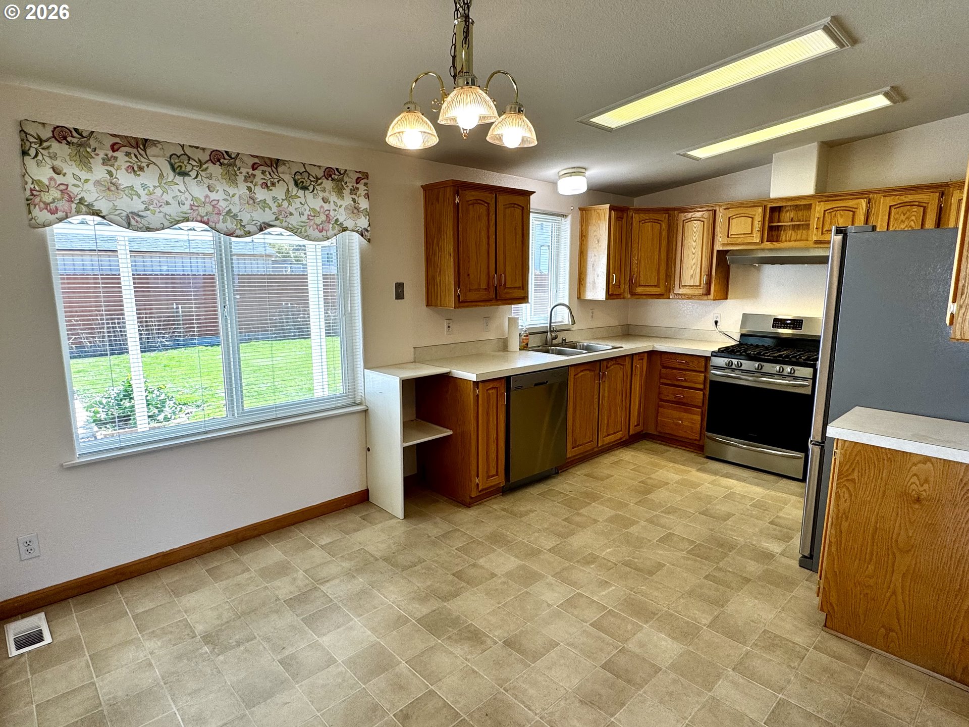 1070 Grove Street Baker City, OR 97814 - Photo 14 of 30 a kitchen with stainless steel appliances granite countertop a stove sink and cabinets