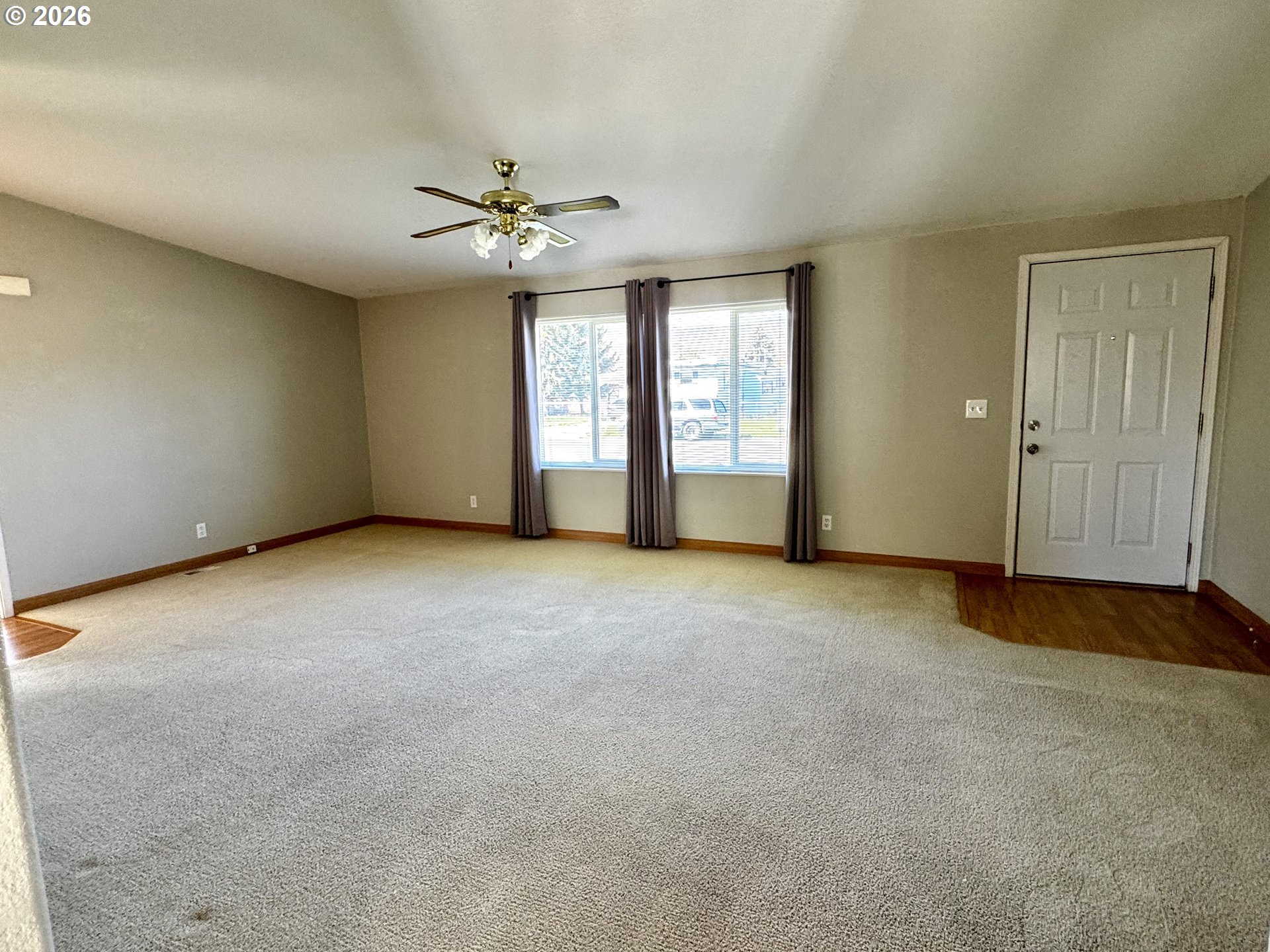1070 Grove Street Baker City, OR 97814 - Photo 2 of 30 a view of a livingroom with a ceiling fan and window