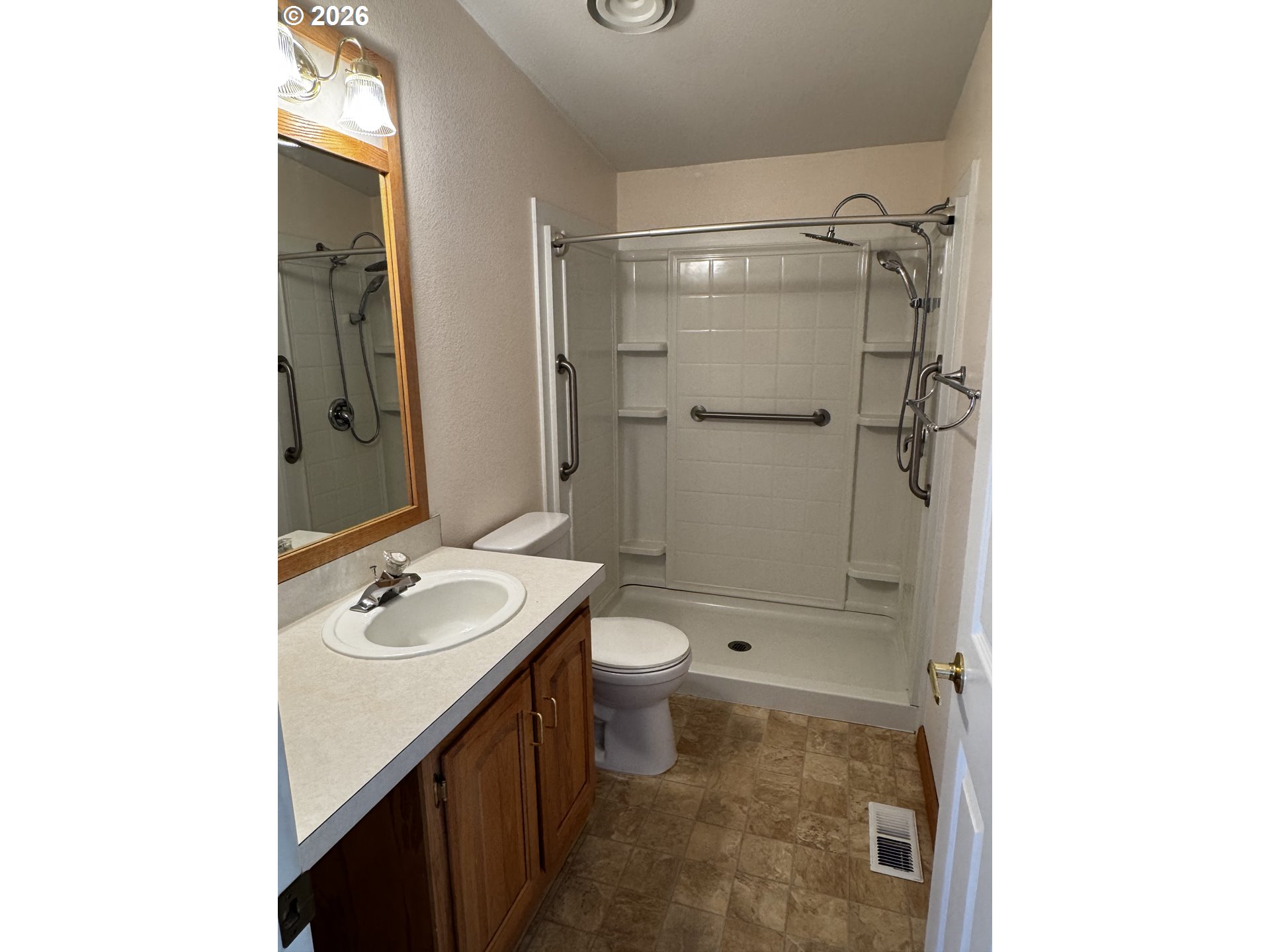 1070 Grove Street Baker City, OR 97814 - Photo 5 of 30 a bathroom with a granite countertop sink toilet and shower