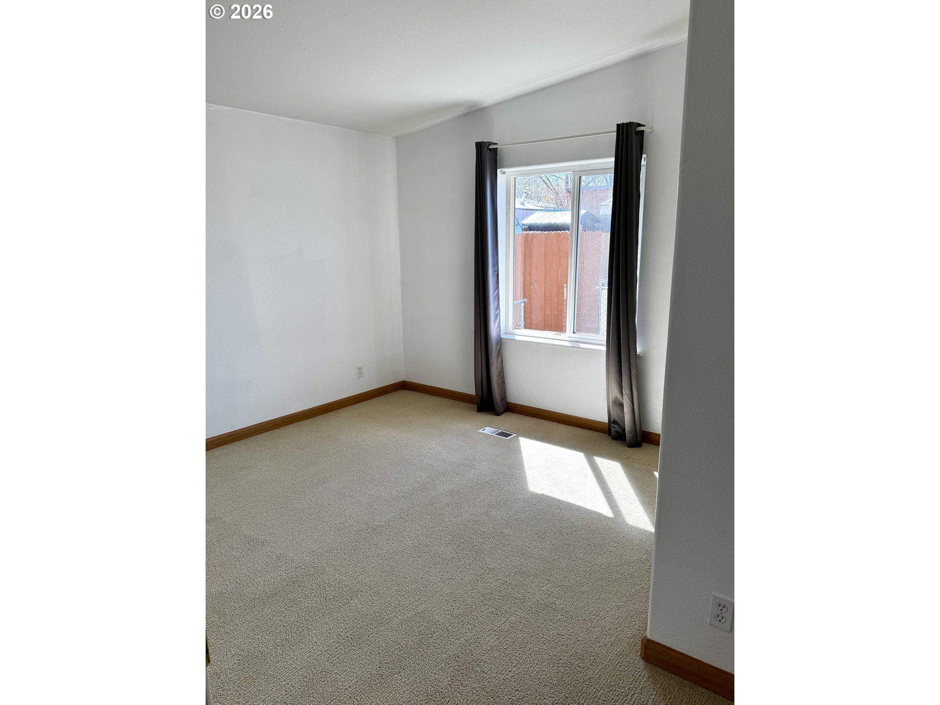 1070 Grove Street Baker City, OR 97814 - Photo 6 of 30 a view of an empty room with a window