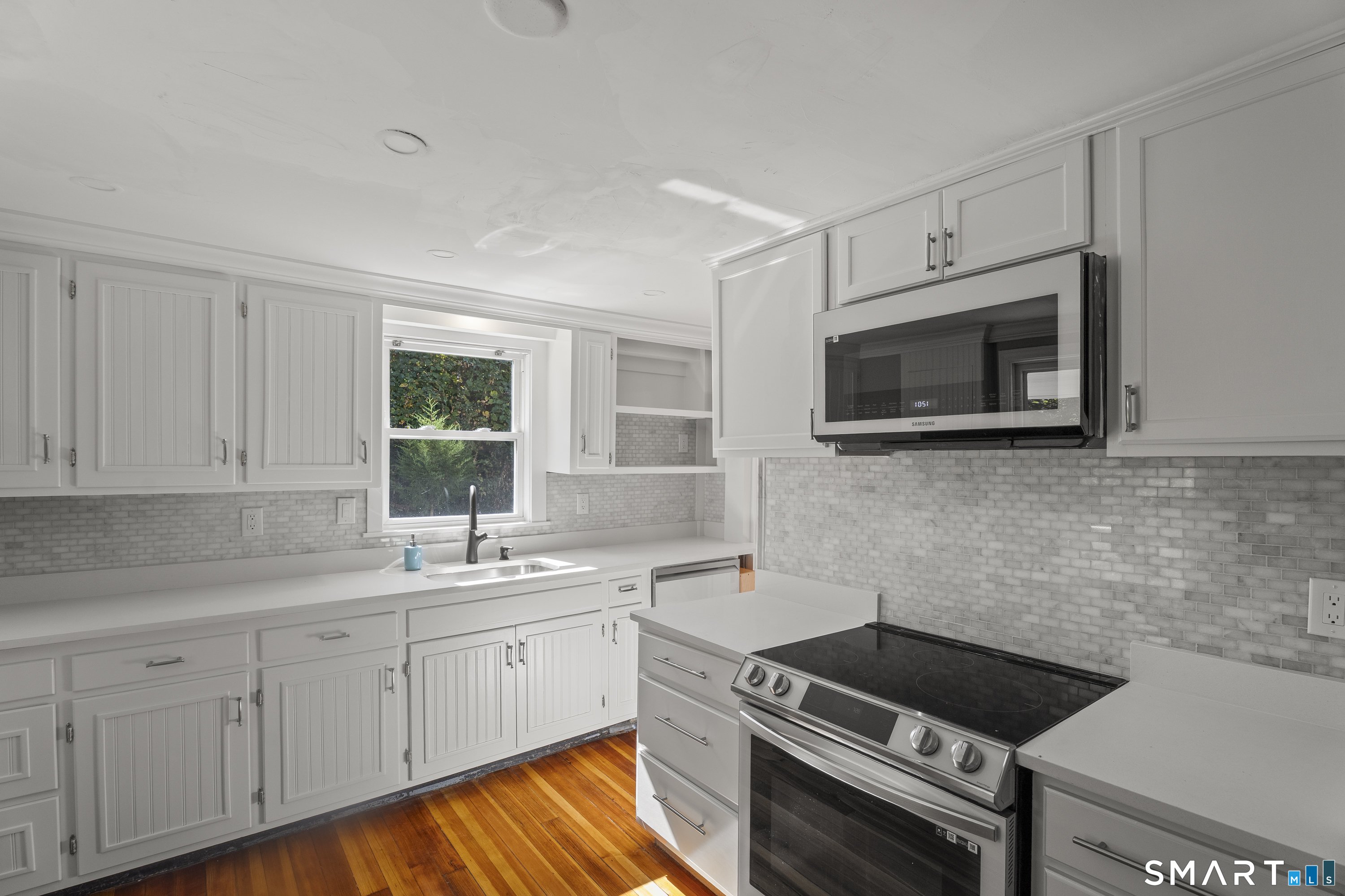 52 B Millstone Road West Waterford, CT 06385 - Photo 11 of 31 a kitchen with a sink stove and microwave