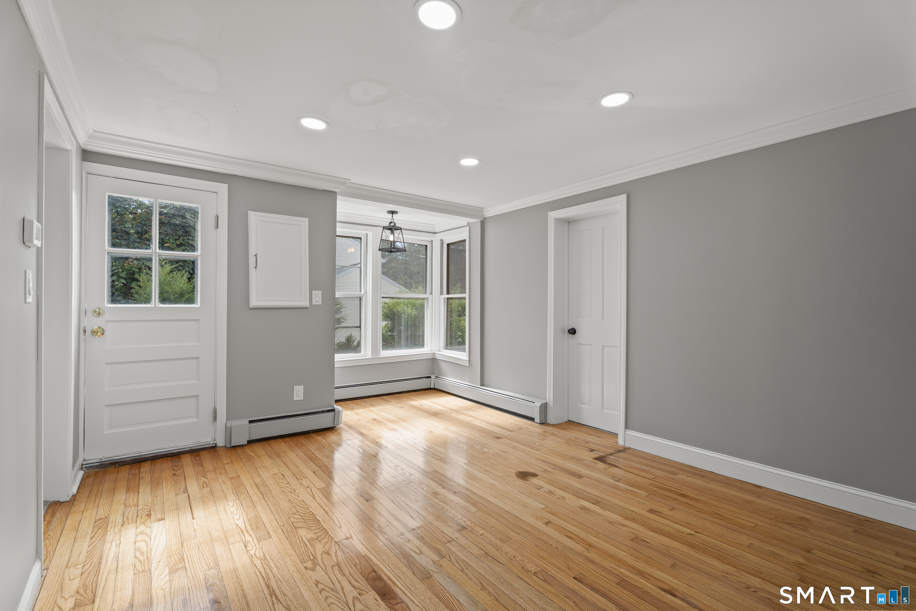 52 B Millstone Road West Waterford, CT 06385 - Photo 16 of 31 a view of an empty room with wooden floor and a window
