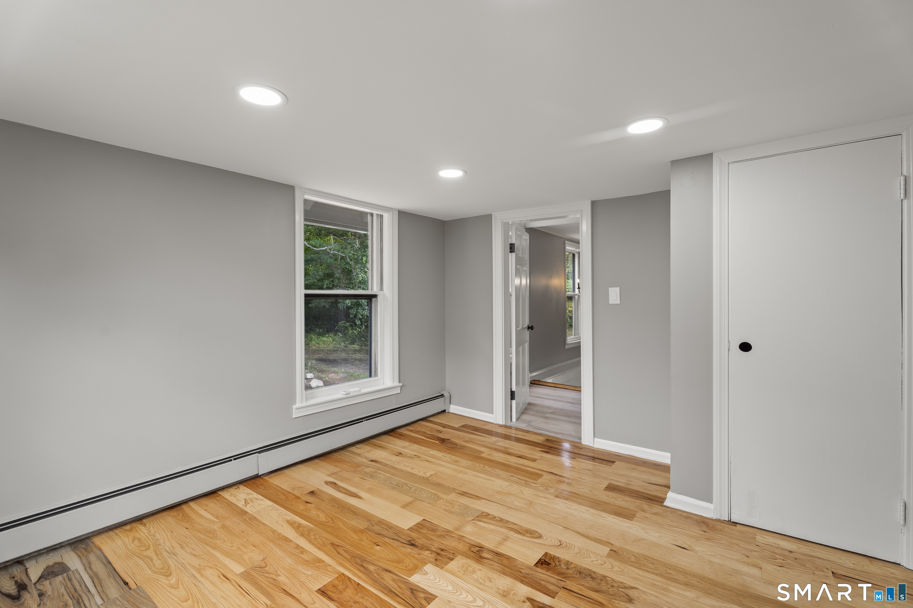 52 B Millstone Road West Waterford, CT 06385 - Photo 21 of 31 a view of an empty room with wooden floor and a window