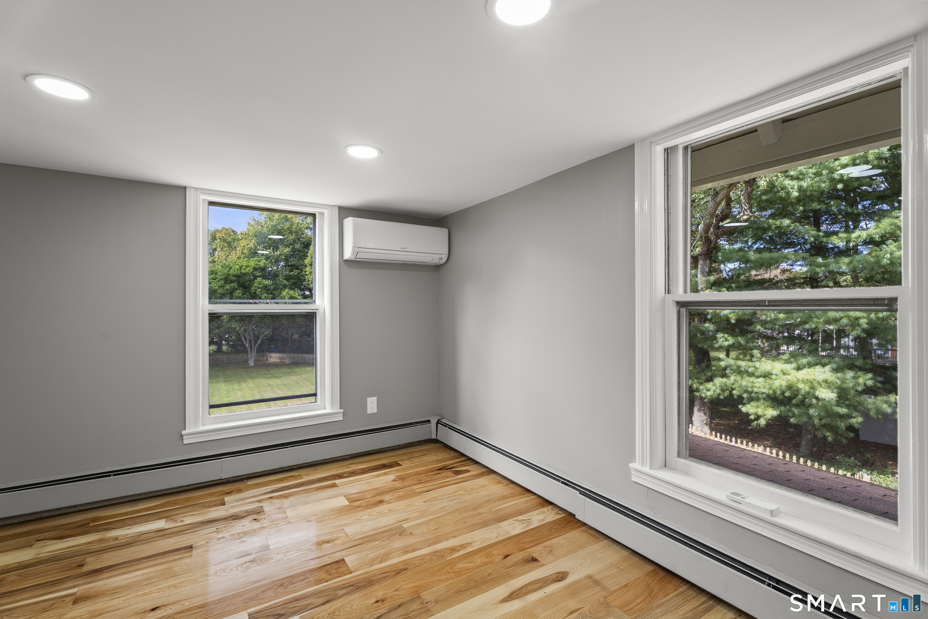 52 B Millstone Road West Waterford, CT 06385 - Photo 22 of 31 a view of an empty room with wooden floor and a window