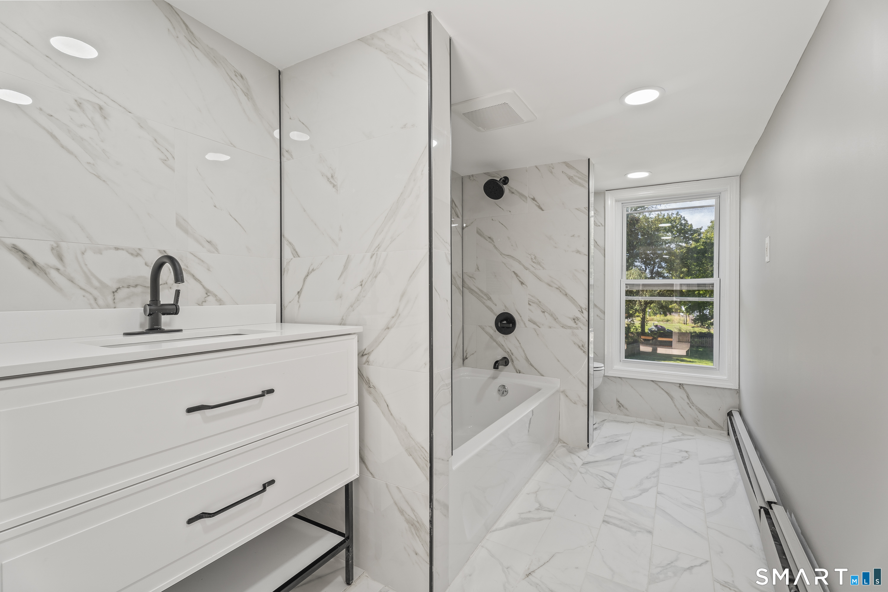 52 B Millstone Road West Waterford, CT 06385 - Photo 26 of 31 a bathroom with a tub sink and mirror