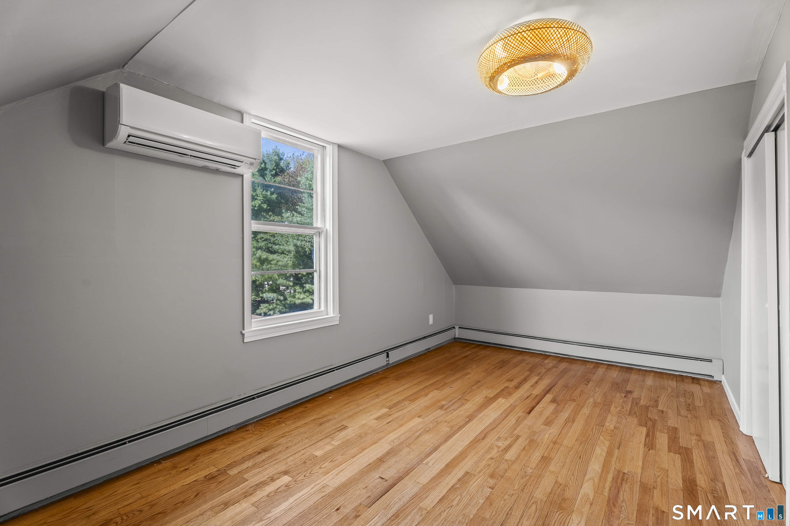 52 B Millstone Road West Waterford, CT 06385 - Photo 29 of 31 a view of a room with wooden floor and windows