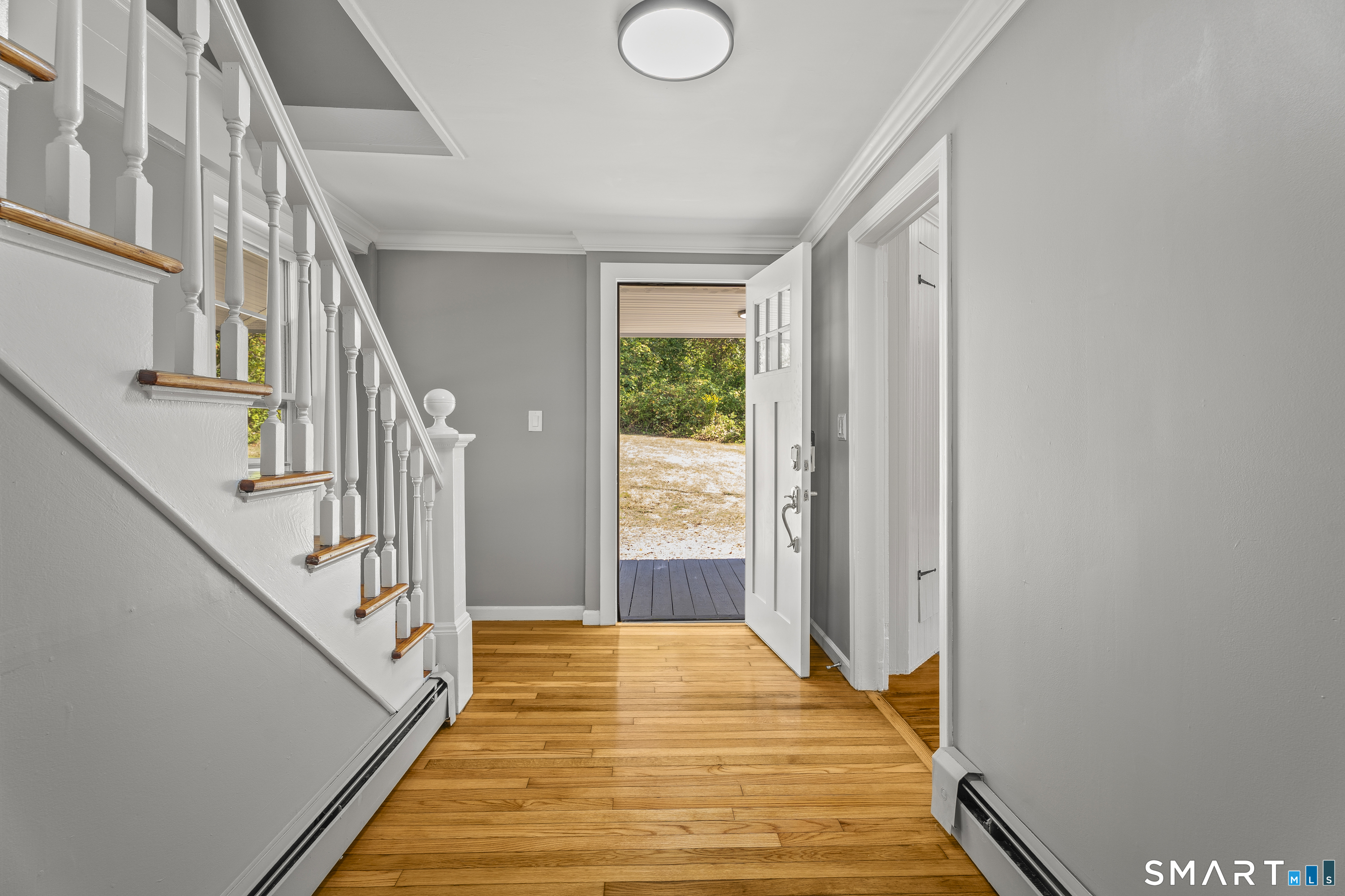 52 B Millstone Road West Waterford, CT 06385 - Photo 8 of 31 a view of a hallway with wooden floor and staircase