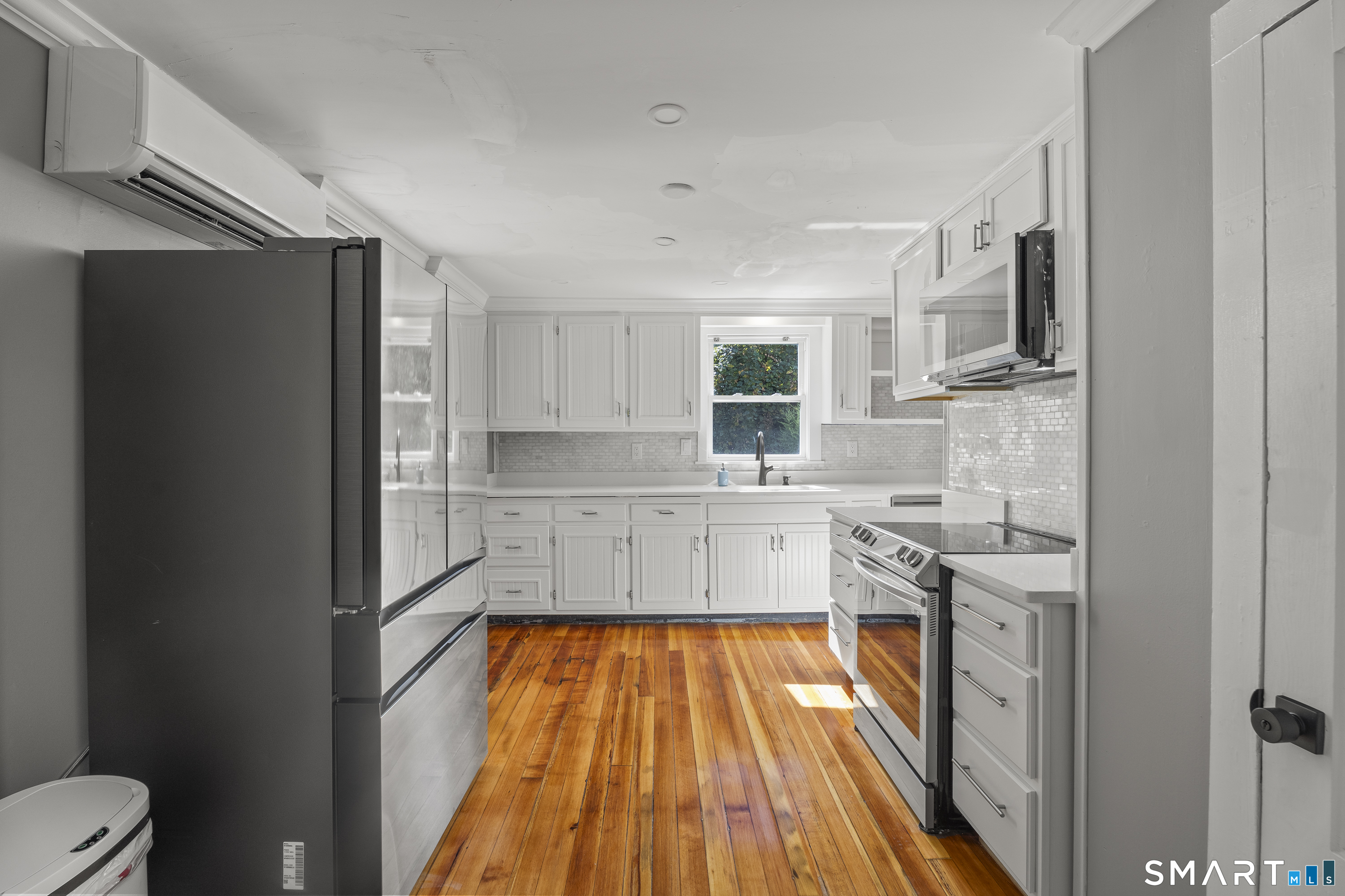 52 B Millstone Road West Waterford, CT 06385 - Photo 10 of 31 a kitchen with stainless steel appliances a stove a sink and a refrigerator