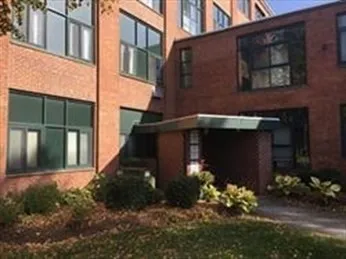 a view of a dining room with furniture and a floor to ceiling window