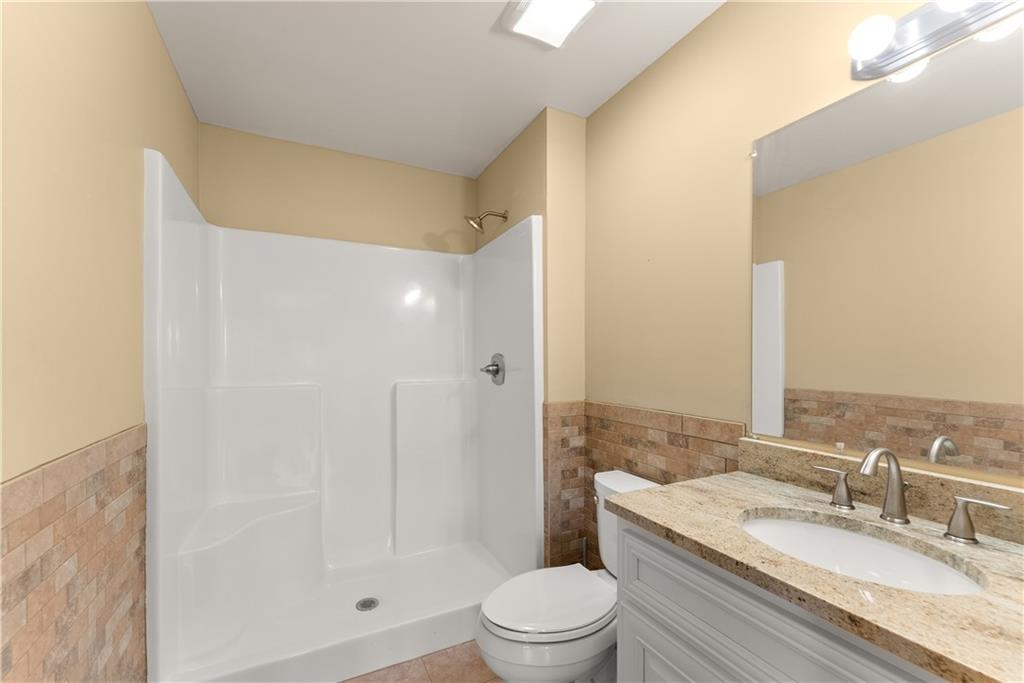 725 County Farm Road Jefferson, GA 30549 - Photo 42 of 66 a bathroom with a granite countertop sink a toilet and shower