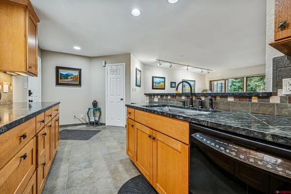 a bathroom with a granite countertop sink toilet a mirror and shower