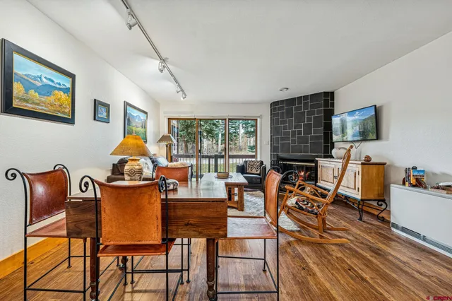 a living room with furniture a fireplace and a flat screen tv