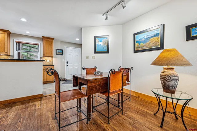 a view of a dining room with furniture and wooden floor