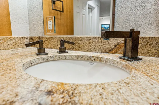 a bathroom with a tub sink and mirror