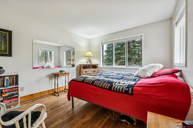 a bedroom with a bed window and a table chair