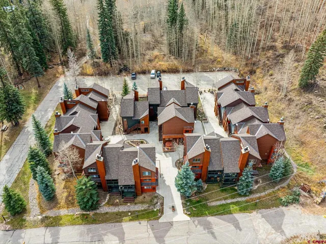 an aerial view of residential house with outdoor space and parking