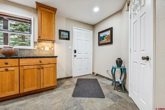 a hallway with sink and a refrigerator