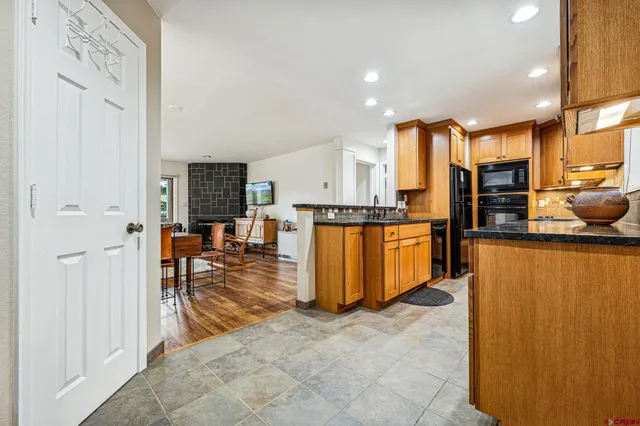 a kitchen with stainless steel appliances a refrigerator and a stove top oven