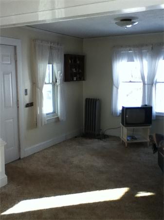 43 Upland Street Springfield, MA 01104 - Photo 5 of 6 a living room with furniture and a window