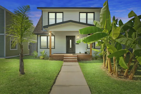 a front view of a house with a yard