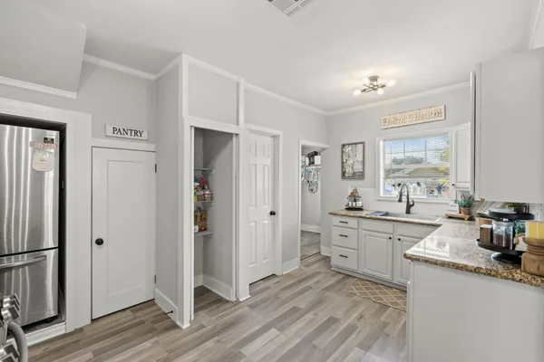 a room with a sink and a refrigerator