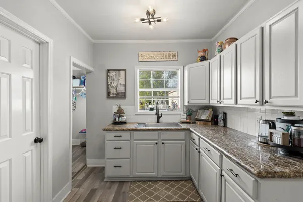a kitchen with a sink stove and cabinets