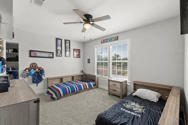 a bedroom with furniture and a window