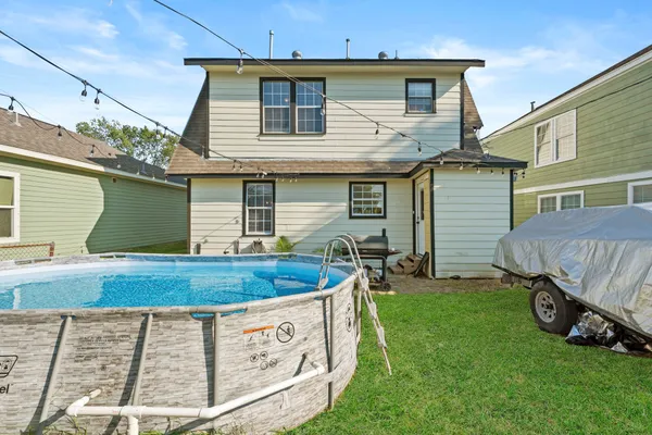 a view of a house with a yard and sitting area