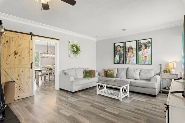 a living room with furniture and a painting on the wall