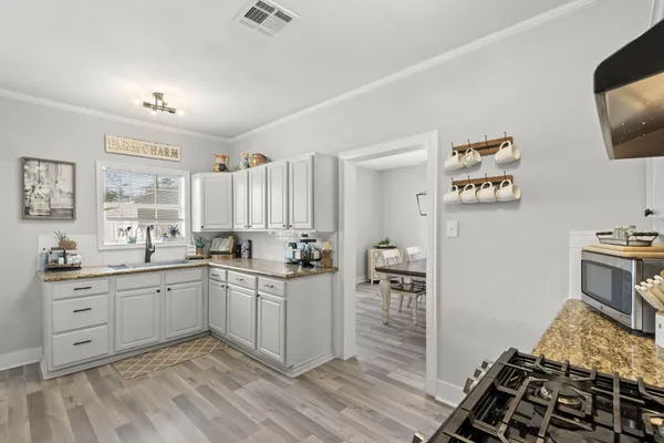 a kitchen with sink cabinets and stove