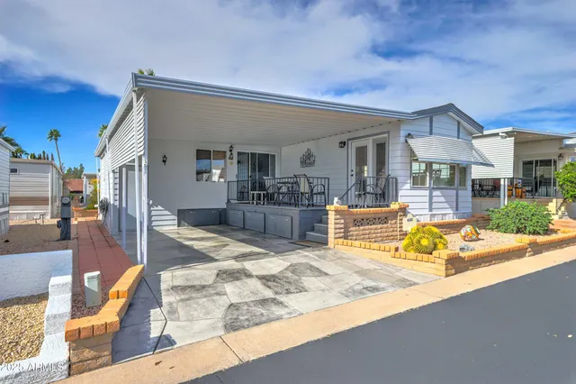 a view of a house with wooden floor and swimming pool in front of residential house
