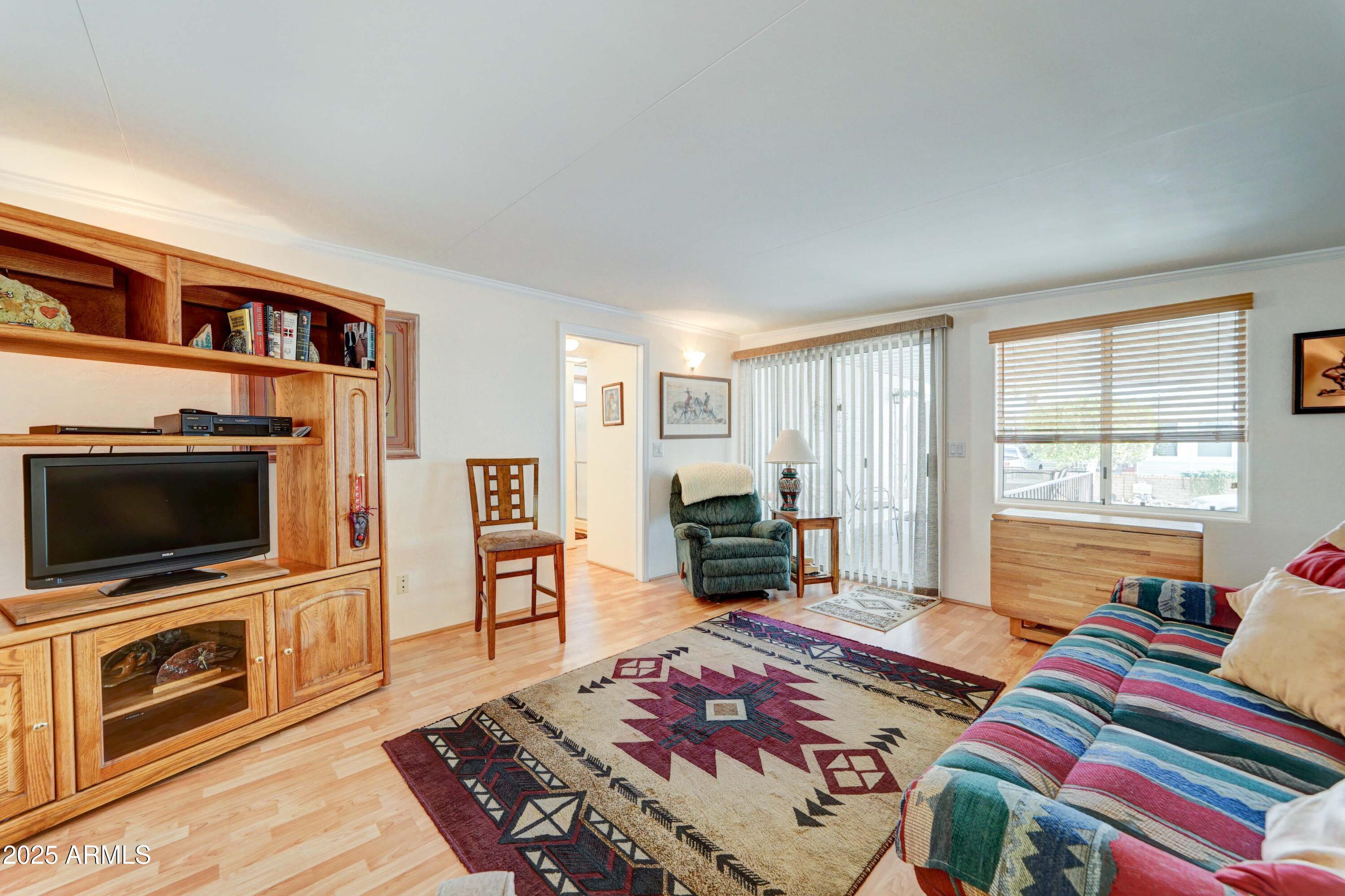 111 South Greenfield Road, Unit 440 Mesa, AZ 85206 - Photo 18 of 31 a living room with furniture and a flat screen tv