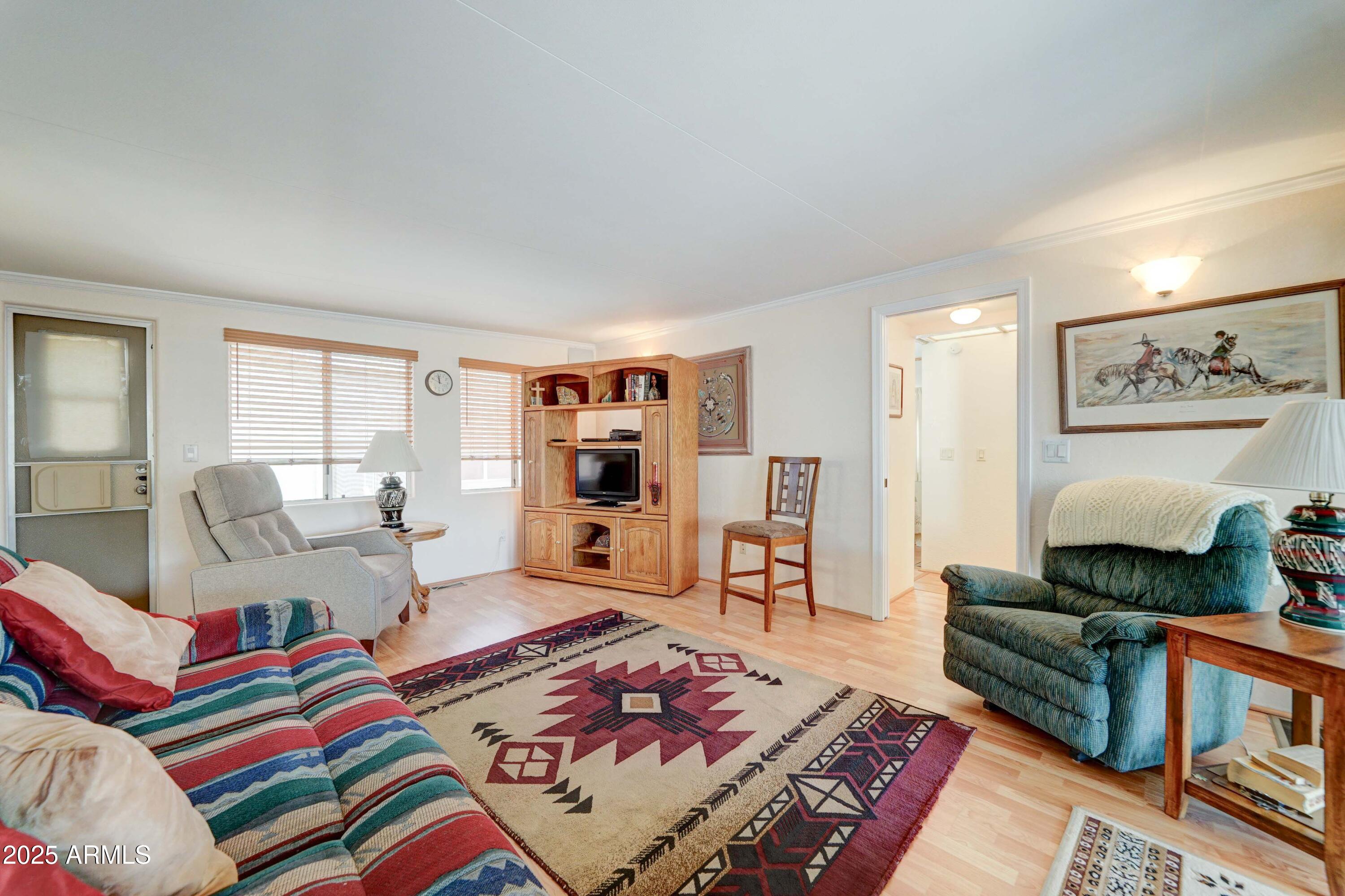 111 South Greenfield Road, Unit 440 Mesa, AZ 85206 - Photo 19 of 31 a living room with furniture and a rug